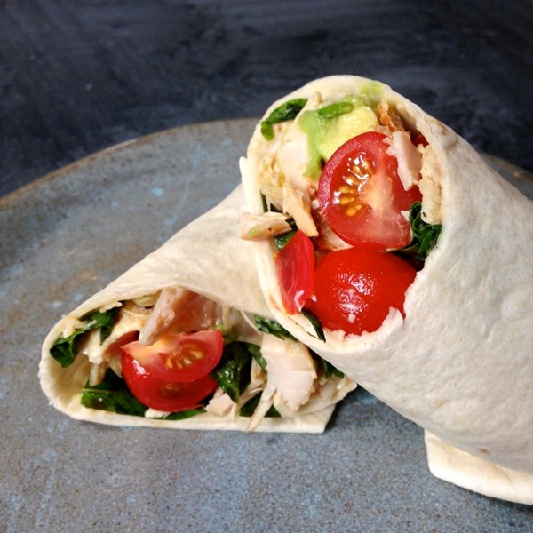Rotisserie chicken wrap with avocado, tomatoes and basil