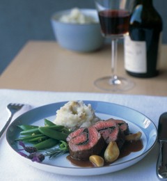 Roulade of herbed lamb with stewed garlic