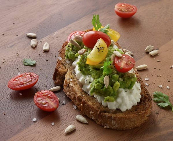 Rustic cheese, avocado, and tomato crostini