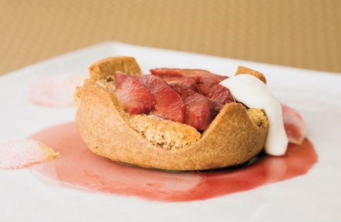 Rustic quince tart with buttery almond cake, mascarpone cream, and pomegranate sauce