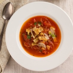 Rustic tomato soup with basil oil and croustades