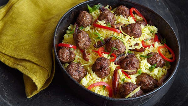 Saffron rice pilaf with lamb meatballs, red peppers, and dates