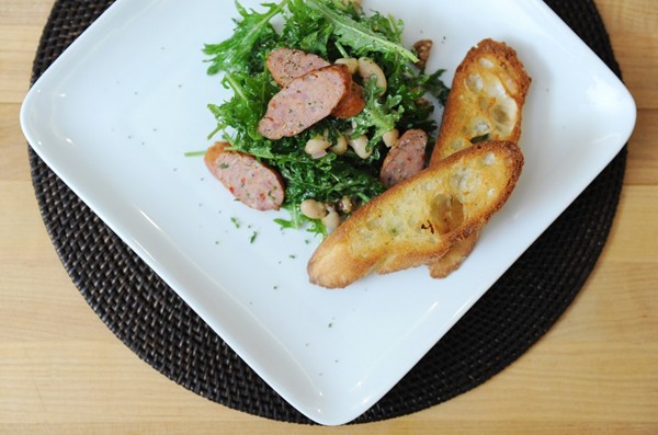 Salad of baby kale, cannellini beans, walnuts and fennel sausage