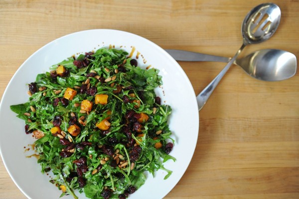 Salad of roasted butternut squash, arugula, dried cranberries and pine nuts
