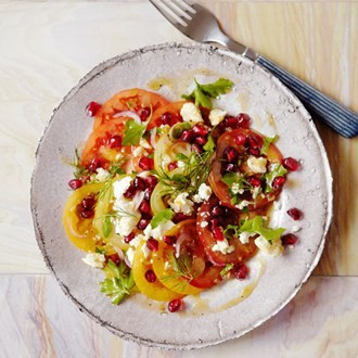Salad of tomatoes, soft herbs and barrel-aged feta with pomegranate dressing