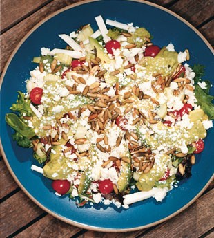 Salad with avocado-lime vinaigrette and spicy pumpkin seeds
