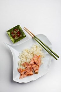 Salmon and sushi rice with hot, sweet and sour Asian sauce