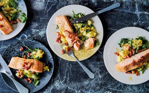 Salmon fillets  on crushed potatoes with bacon and spring onion dressing