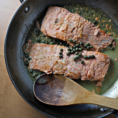 Salmon in a lemon caper sauce over mashed cannellini beans and broccoli rabe