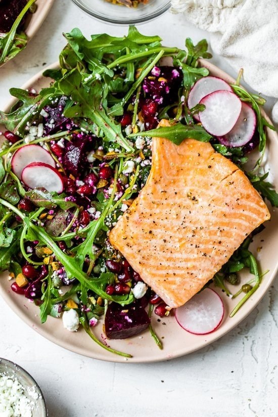 Salmon salad with beets, arugula, pistachios and pomegranates