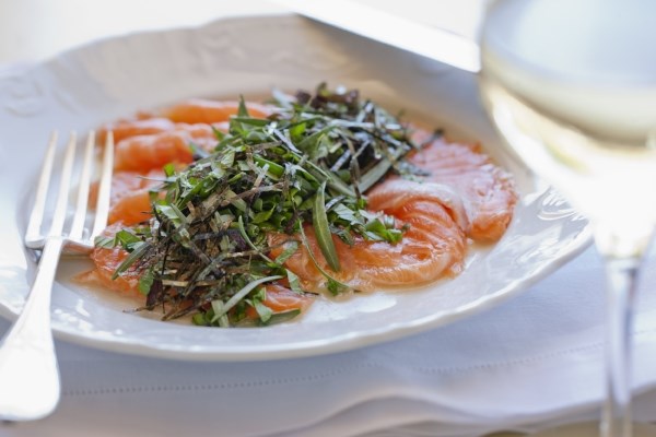 Salmon sashimi with an avalanche of herbs