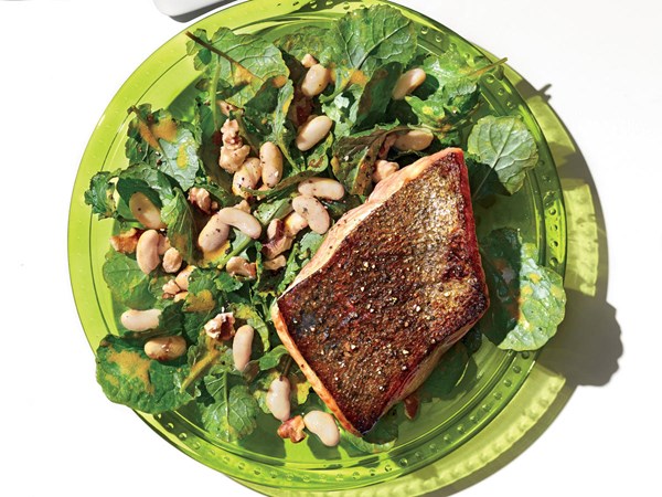 Salmon with kale, walnut, and white bean salad