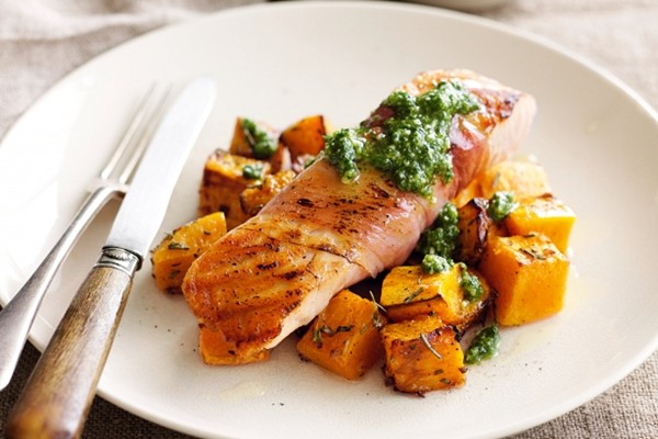 Salmon wrapped in prosciutto with pesto and roast pumpkin