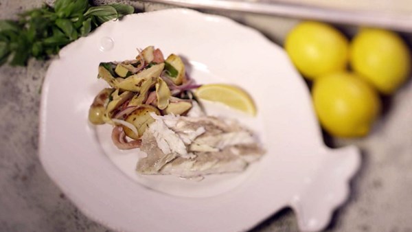 Salt baked sea bass with warm artichoke and bacon salad