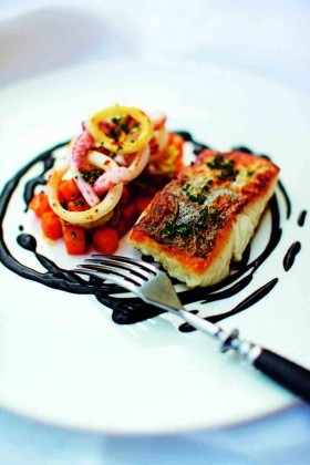 Salt hake with squid ink, parsley, and tomato and garlic sauce