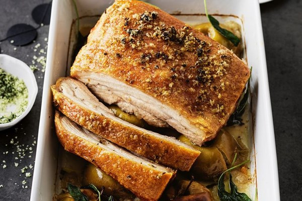 Salt-roasted pork belly with whole apples and quince sauce