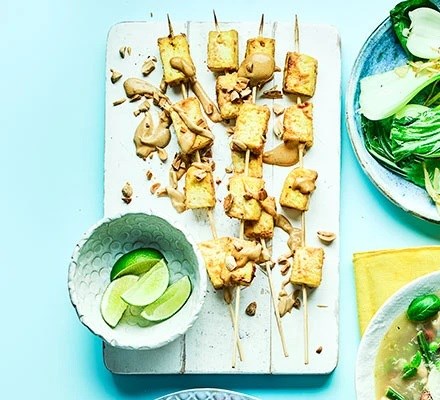 Satay tofu skewers with garlic and ginger pak choi