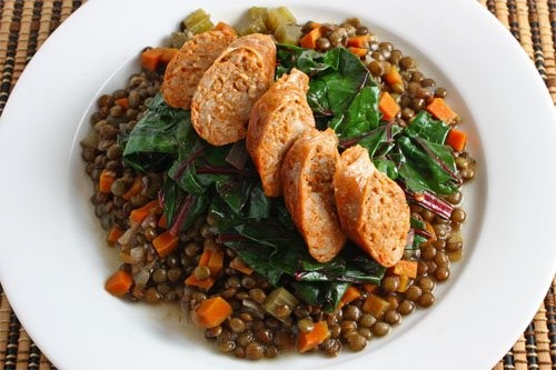 Sausage on lentils and greens