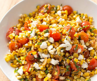 Sautéed corn with cherry tomatoes, ricotta salata, and basil