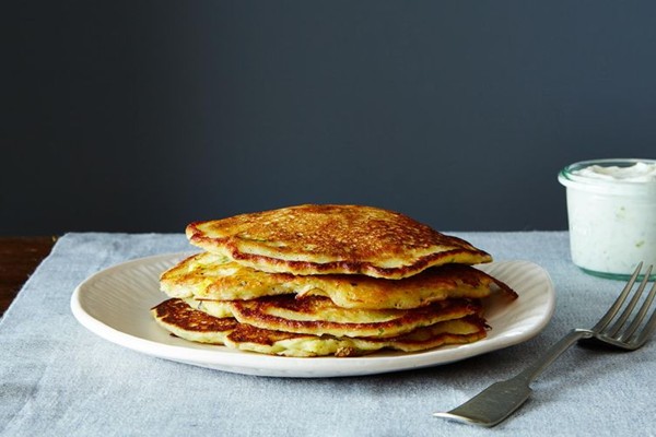 Savory masa corn cakes with green chile, cheese, and lime crema