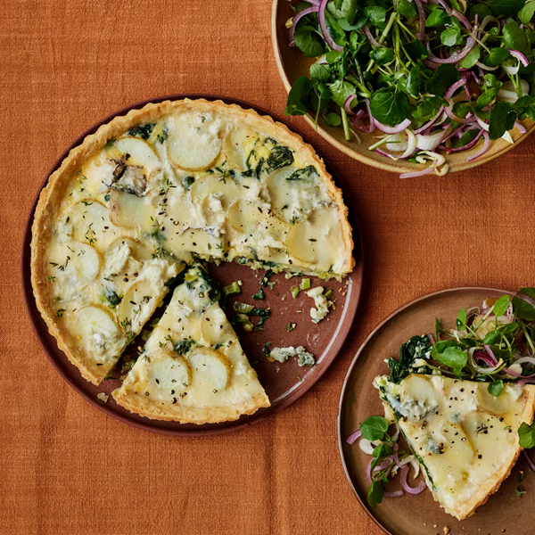 Savoury tart with potato, leek, Gorgonzola and spinach, with watercress and red onion salad