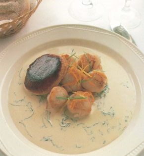 Scallops served in a pastry case with a cream and basil sauce