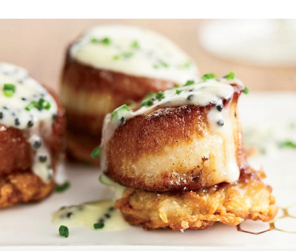 Scallops with potato pancakes and caviar sauce