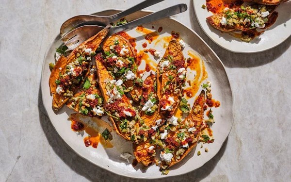 Scored roast sweet potatoes with goat’s cheese, olives and ’nduja oil