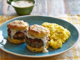 Scrambled eggs on buttermilk biscuits with sausage and cream gravy