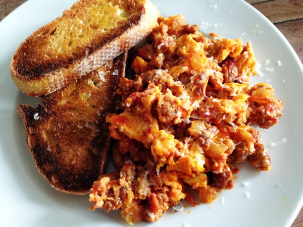 Scrambled eggs with sausage, tomatoes, & pecorino