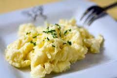 Scrambled eggs with sautéed asparagus.