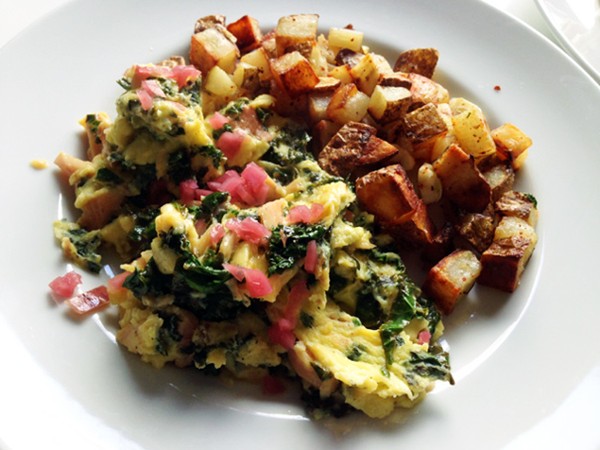Scrambled eggs with smoked trout, pickled onions and kale