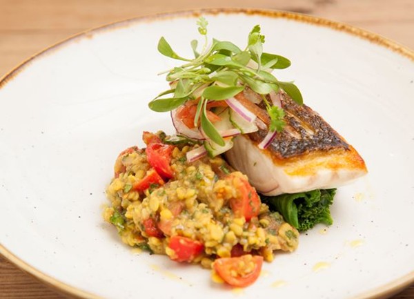 Sea bass with tarka dhal, coriander salad and buttered kale