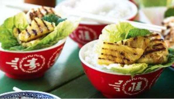Seafood and bacon cakes with grilled pineapple in lettuce leaves