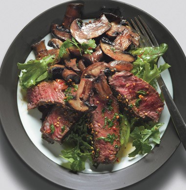 Seared Asian steak and mushrooms on mixed greens with ginger dressing