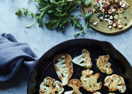 Seared cauliflower with arugula, dried cranberries, and hazelnuts