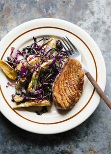 Seared duck breast with brown sugar-vinegar cabbage, roasted potatoes, and herb salad