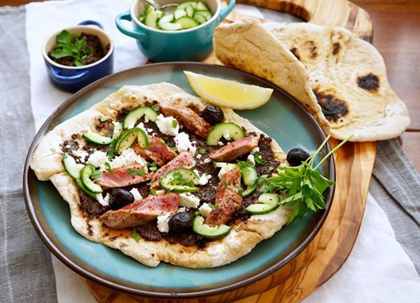 Seared lamb flatbreads with olive tapenade, feta and quick-pickled cucumber