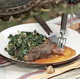 Seared rib-eye cutlets with romesco sauce and wilted spinach with olives