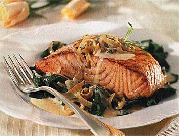 Seared salmon on baby spinach