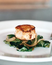 Seared scallops with braised collard greens and cider sauce