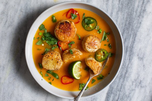 Seared sea scallops with spicy carrot coulis