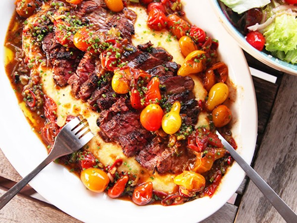 Seared skirt steak with blistered cherry tomatoes and polenta