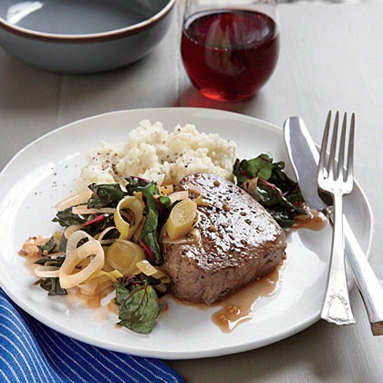 Seared steak with braised leeks and chard