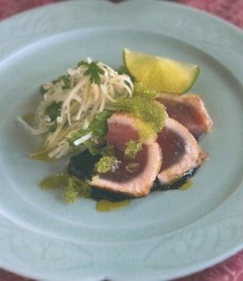 Seared tuna on nori sauce with green papaya, mango, jicama and fresh coconut salad and wasabi tobikko