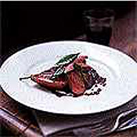 Seared venison steaks with baked pear and red wine sauce