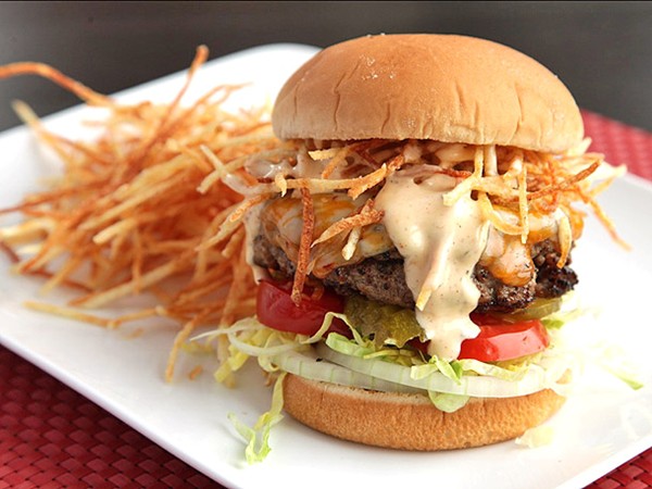Seasoned cheeseburgers with shoestring potatoes and spicy sauce (Cuban fritas)