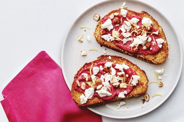 Seeded toast with chévre, beet purée, hazelnuts, and lemon zest