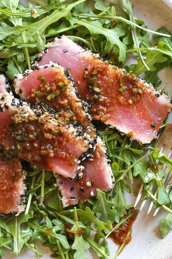 Sesame crusted tuna steak on arugula