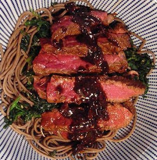Sesame marinated steak on spinach and soba noodles